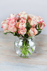 Beautiful cream and pink roses in vase