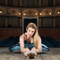 Obraz premium Young classical ballerina dancing inside old theater of Ripatran