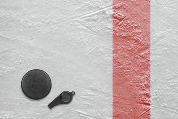 Referee whistle and hockey puck