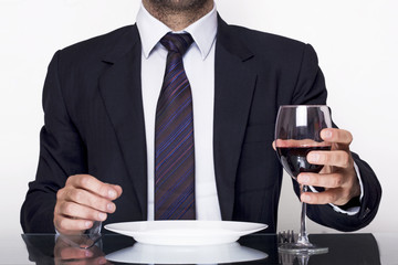 Business dining and holding a glass of wine