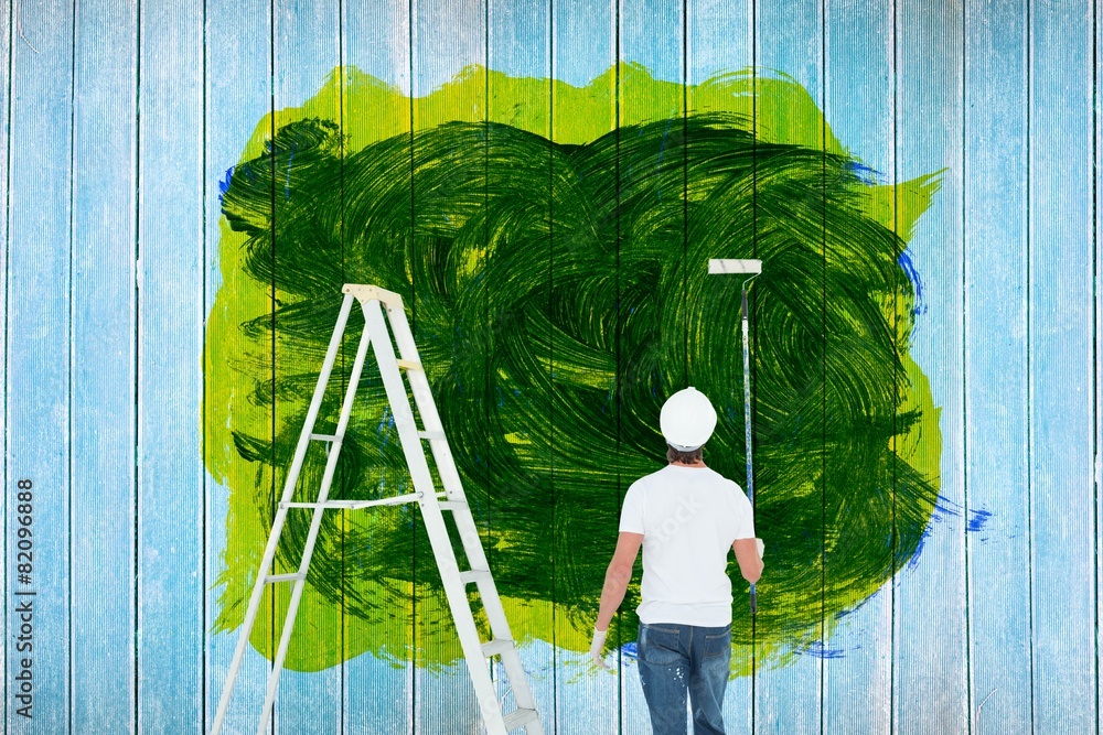 Poster composite image of man with paint roller standing by ladder