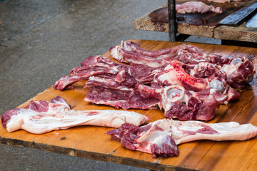 Raw pork  on wooden table at the market .