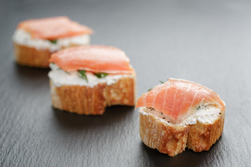 small sandwiches with soft cheese and salmon