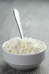 cottage cheese in white bowl on old table