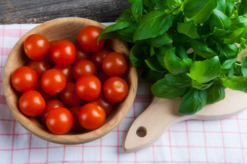 Fresh cherry tomatoes and basil leaves