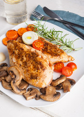 Baked chicken breast with mushrooms and carrots on plate