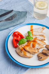 Baked chicken breast sliced on plate