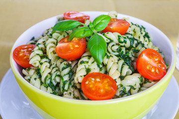 Pasta with spinach and cherry tomatoes.