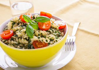 Pasta with spinach and cherry tomatoes.