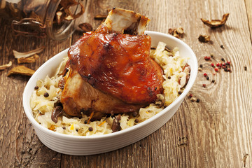 Roast pork knuckle served with boiled cabbage, bread, horseradis