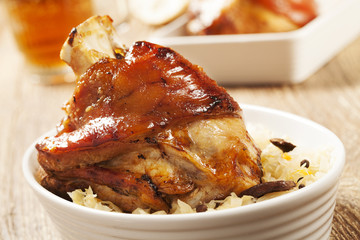 Roast pork knuckle served with boiled cabbage, bread, horseradis