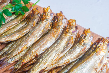 Smoked sprats on cutting board