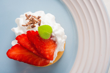 Small biscuit with strawberries and whipped cream