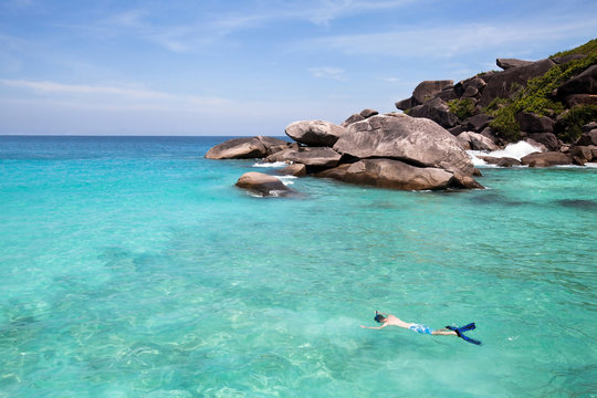 swimming with snorkel in turquoise water near paradise island