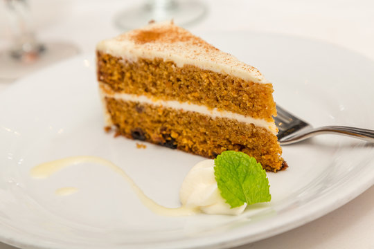 Slice of Carrot Cake with Mint Garnish