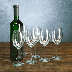 Bottle full of wine with glasses on wooden surface