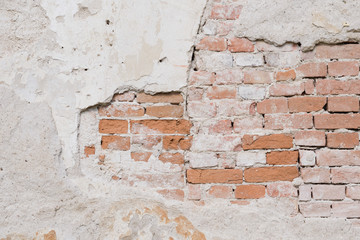 Old wall with plaster and bricks texture