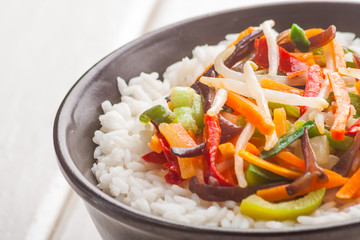 A bowl of rice with vegetables