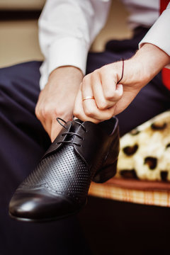 Close up image of a businessman who is preparing for his workday