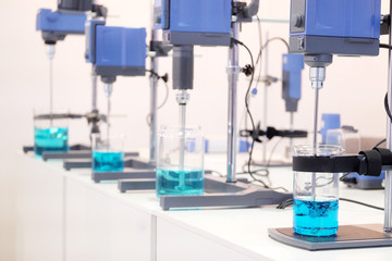 Laboratory equipment. Blue chemical substance in the beaker.