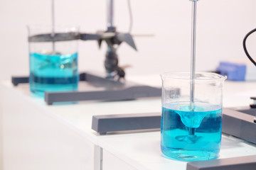 Laboratory equipment. Blue chemical substance in the beaker.