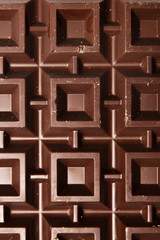 Big plate of dark chocolate on white background