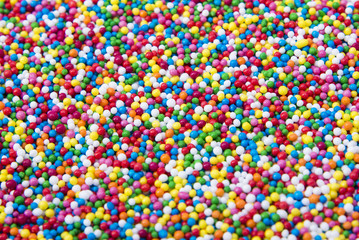 Fototapeta na wymiar Mix of colorful Sugar balls powder background