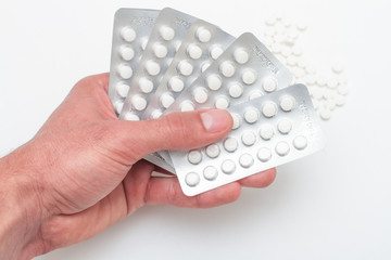 Pills in a blister pack on hands