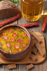 Traditional beer soup with sausage croutons and bread on vintage