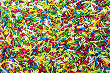 Mix of colorful Sugar sticks powder background