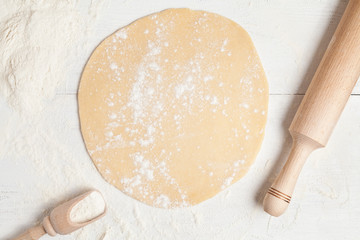 Homemade pie preparation recipe. Dough with rolling pin on white