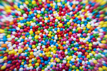 Fototapeta na wymiar Macro of Sugar colorful balls powder background