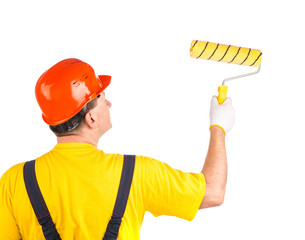 Worker in hard hat with roller