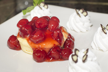 Dessert ,Cheesecake with Berries Sauce and Green Mint on desk in