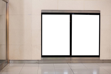 two empty white blank billboards on the wall in metro