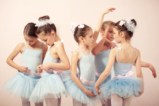 Group of five little ballerinas preparing for performance