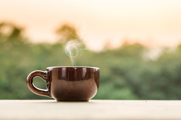 Coffee mug or tea cup with smoke in natural outdoor