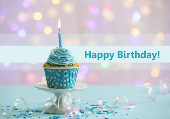 Delicious cupcake on table on light background