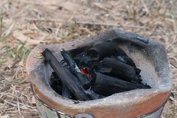 The burning of charcoal in a kiln