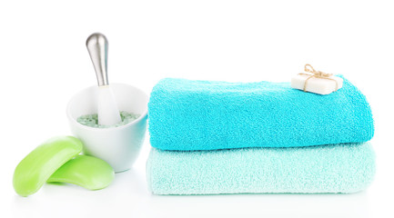 Towels with soap and sea salt isolated on white