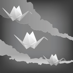 Three paper cranes flying in the sky