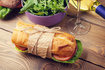 Sandwich, salad and white wine