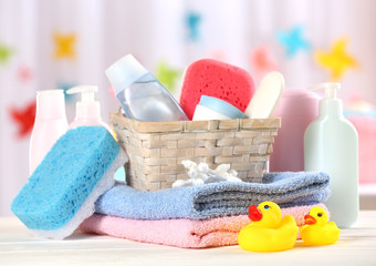 Baby accessories for bathing on table on light background