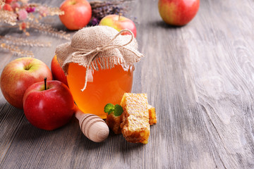 Delicious honey with apple on table close-up