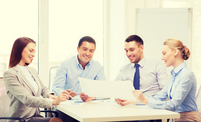 smiling business team having discussion in office