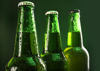 Glass bottles of beer on dark background