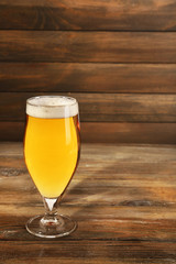 Glass of beer on wooden background
