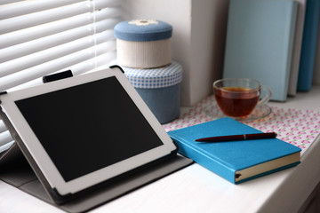 PC tablet, notebook and cup of tea