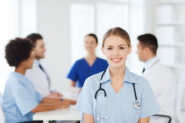 Fototapeta premium happy doctor over group of medics at hospital