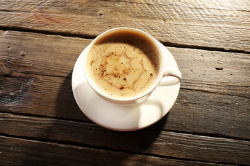 Cup of coffee latte art on wooden background